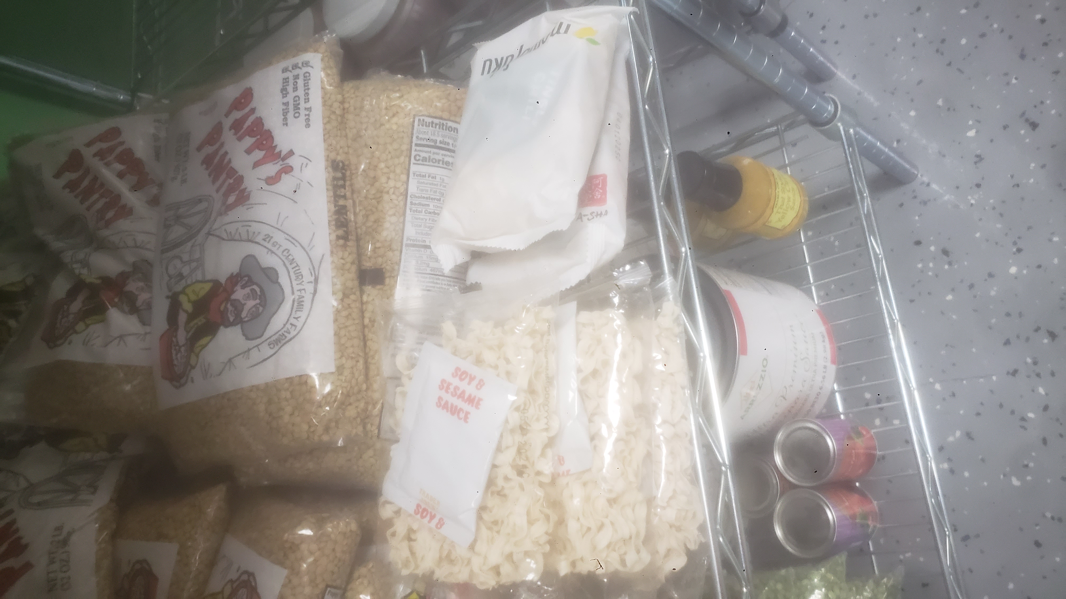 Bags of noodles with bags of lentils behind it.